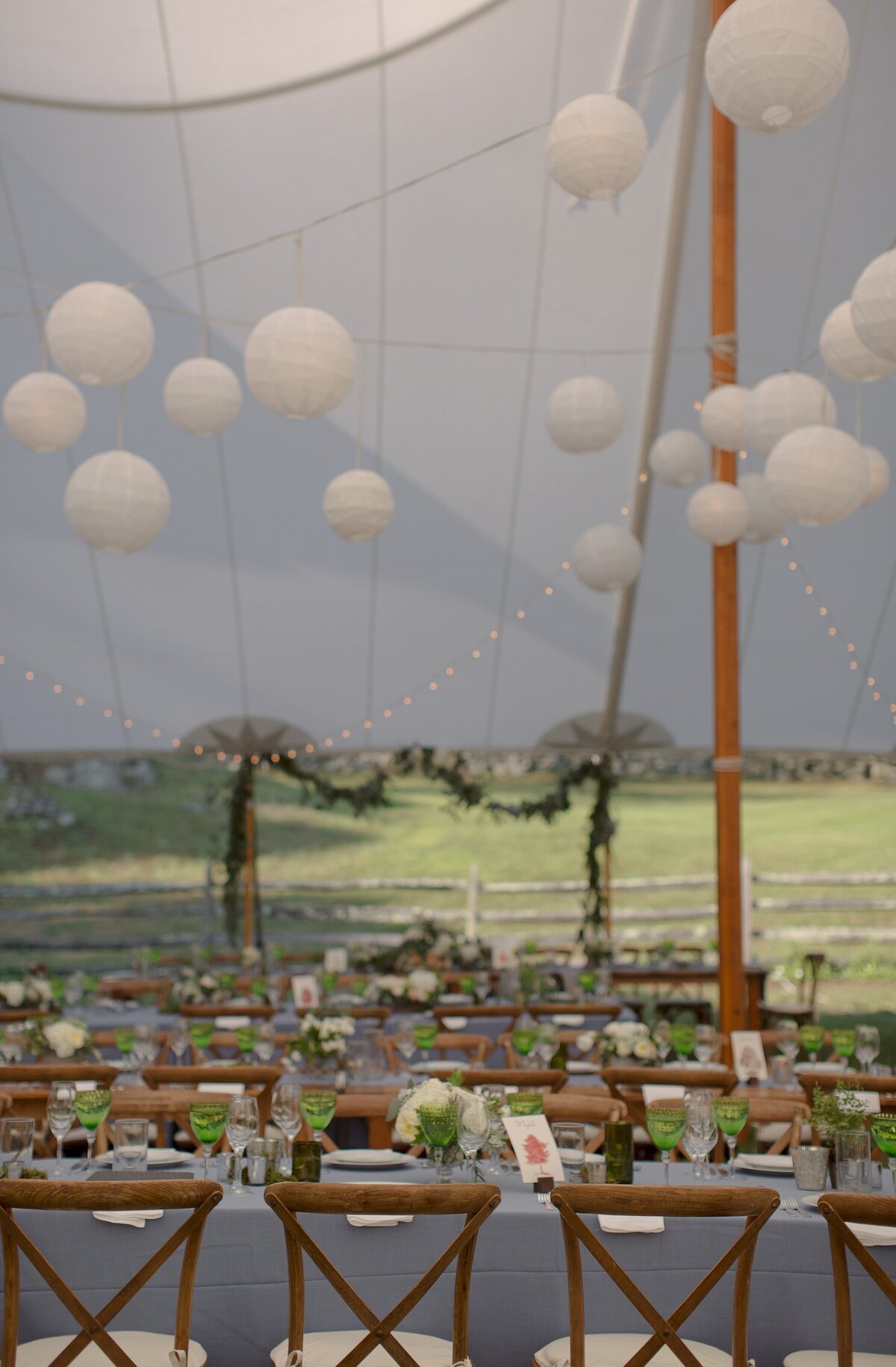 Tented reception tables and decor with bubble lanterns.