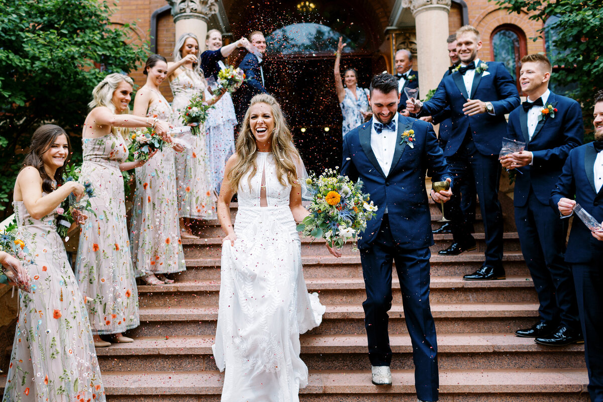 Newlyweds exiting church with cheers and confetes