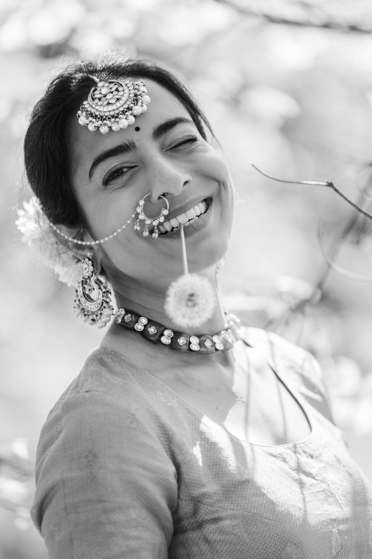 Black and white candid bridal portrait with a dandelion by Hudson Valley wedding photographers