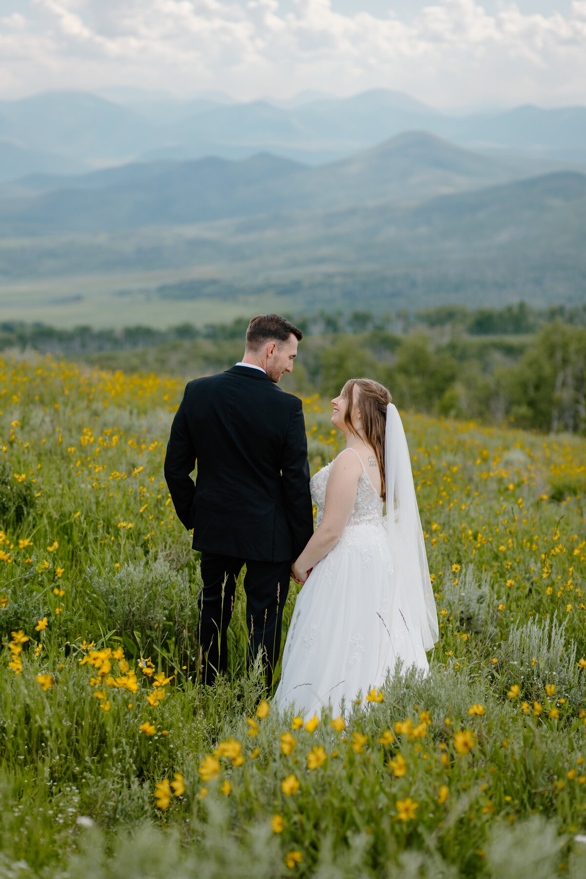 A couple holds hands during their wedding in Steamboat Springs, Colorado.
