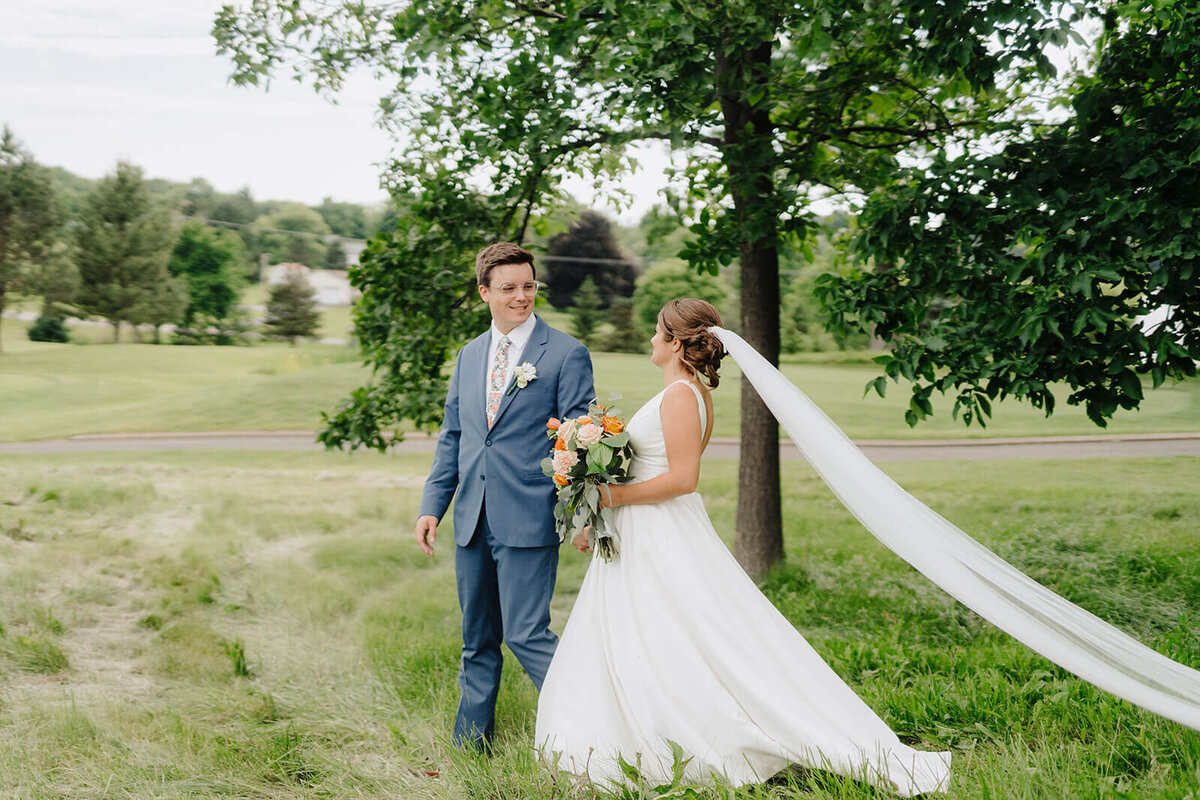 Bride and groom standing in field at Oswego wedding, NY