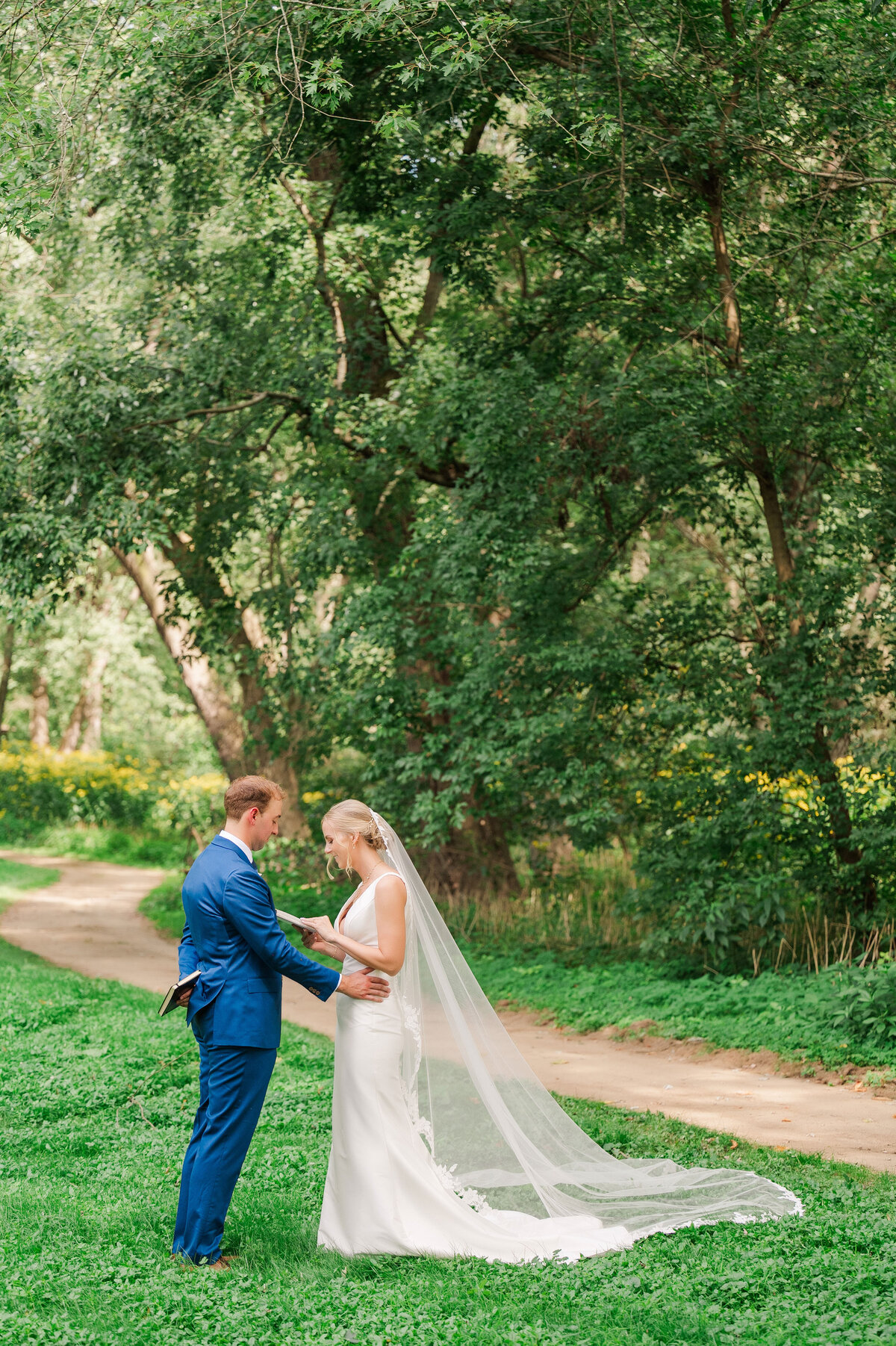 bride and groom reading vows to each other at the boat launch area of YMCA Camp Kon-O-Kwee