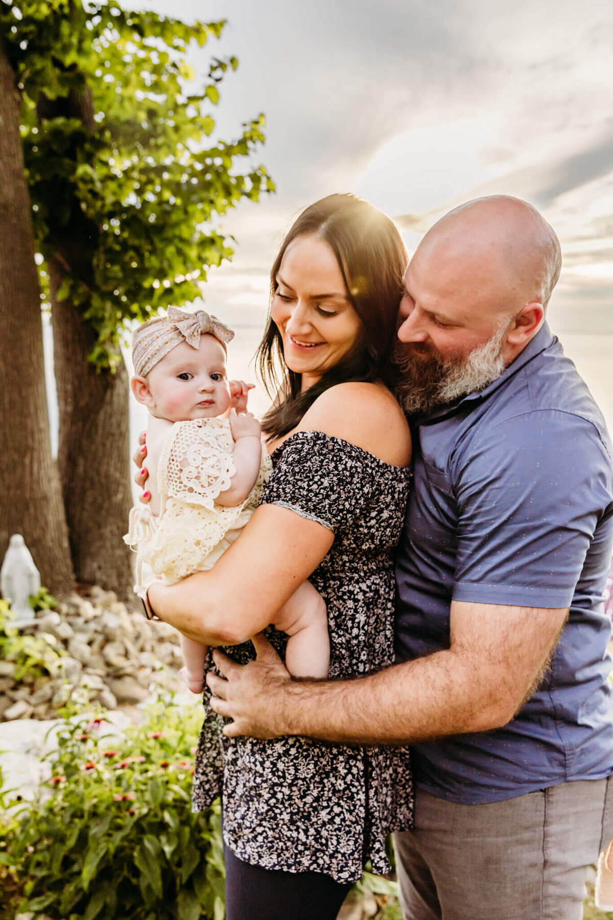 new parents admiring baby girl during family photo session