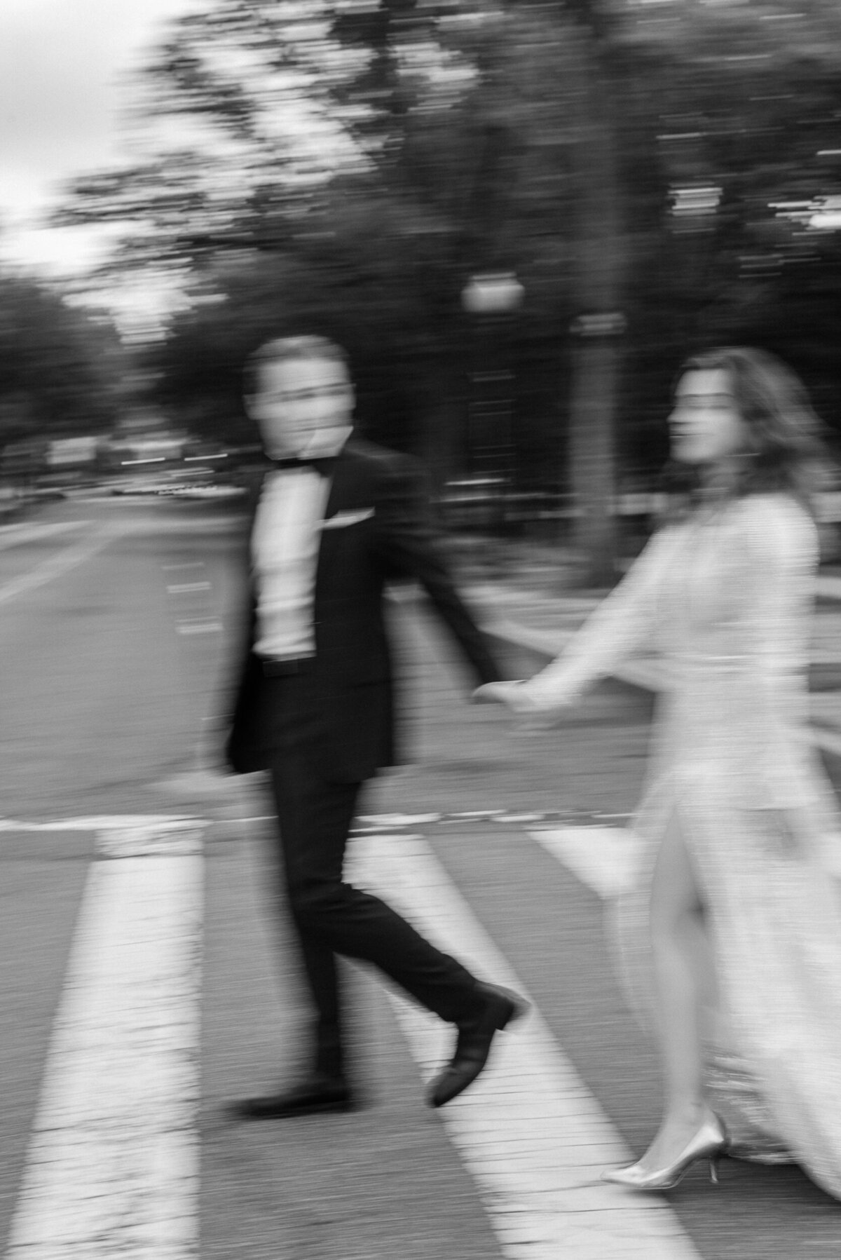 blurry black and white photo of bride and groom crossing a street in washington, dc