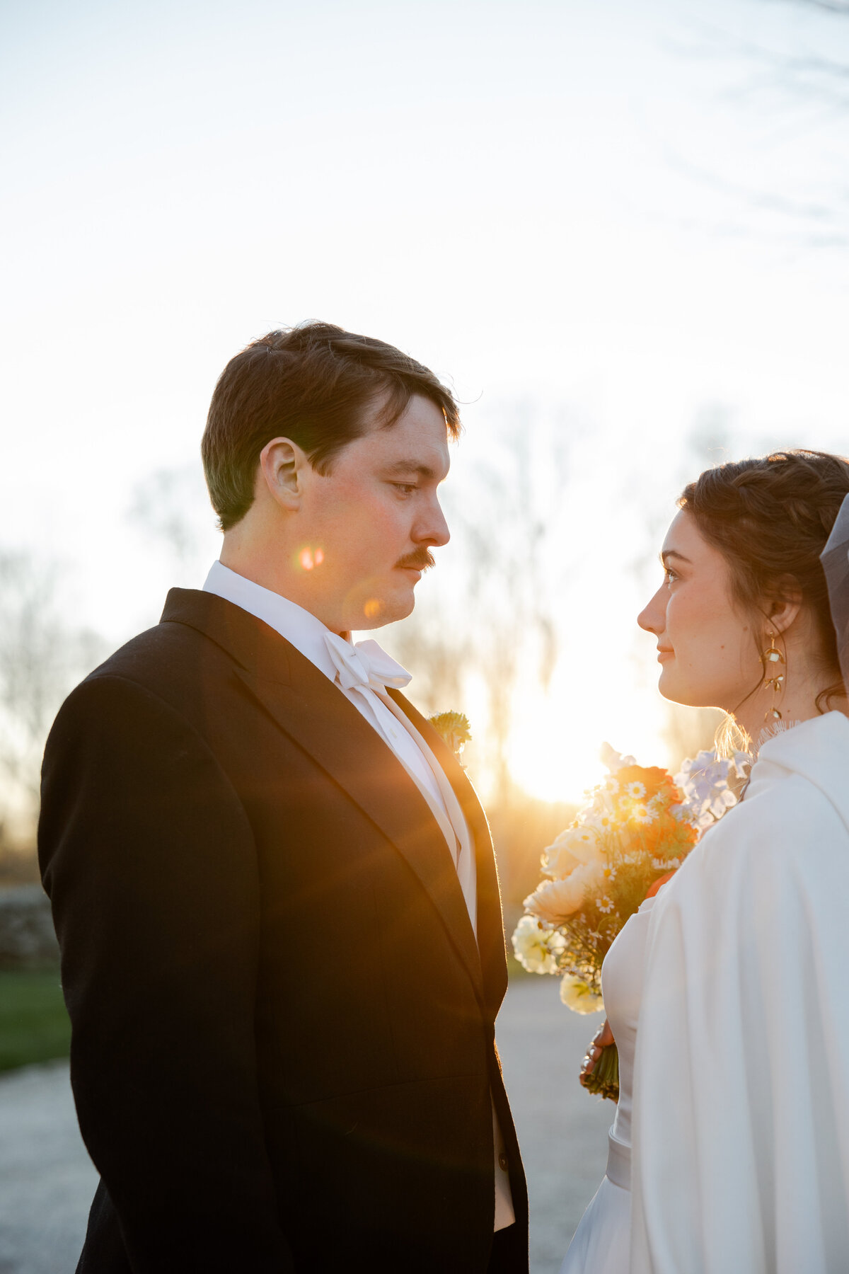 A Wedding portrait in front of a setting sun in Connecticut.