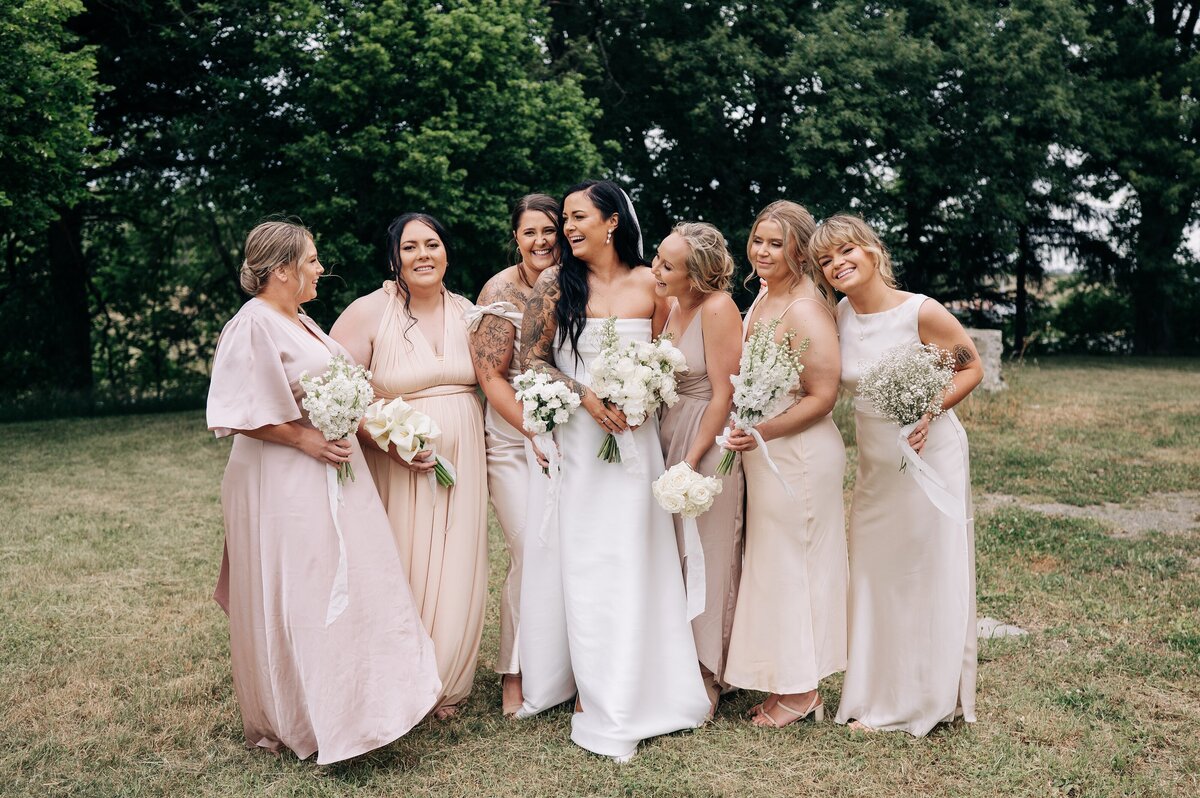 mismatched champagne toned bridesmaids in bridal party in christchurch garden wedding