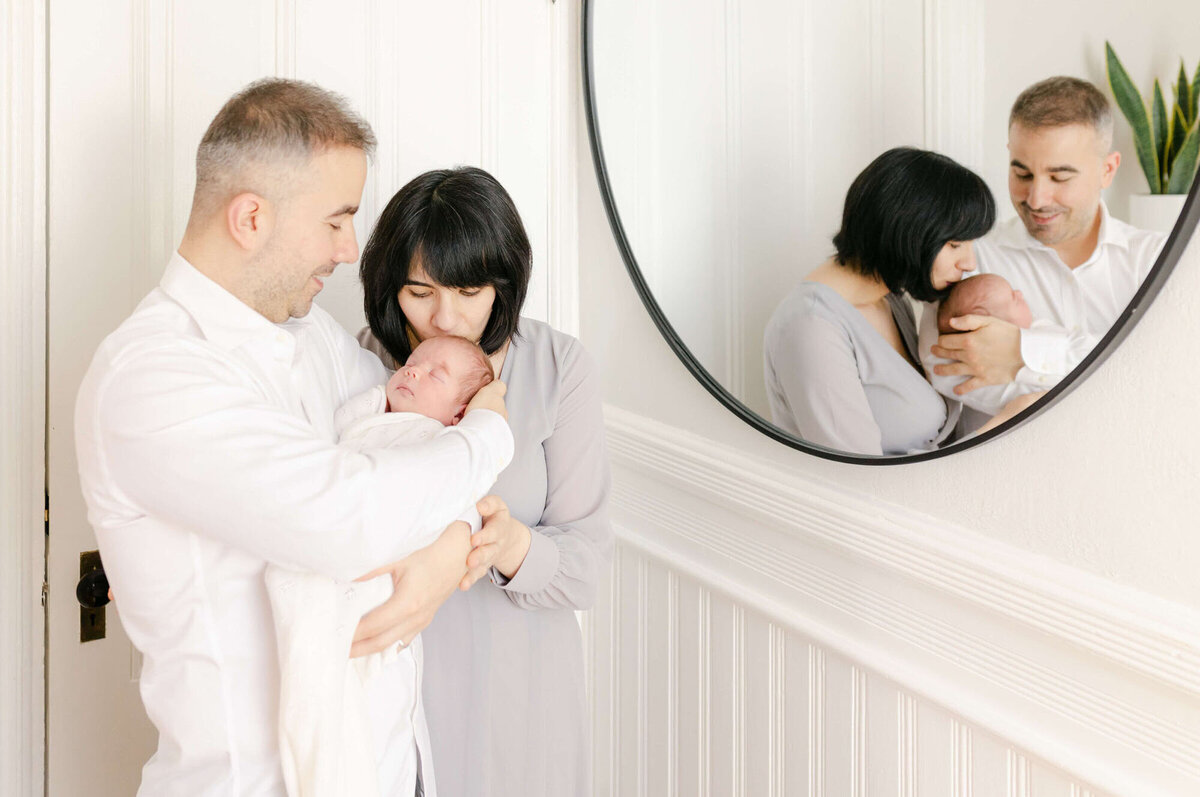 Cozy living room Bay Area newborn photography session with baby wrapped in a blanket.