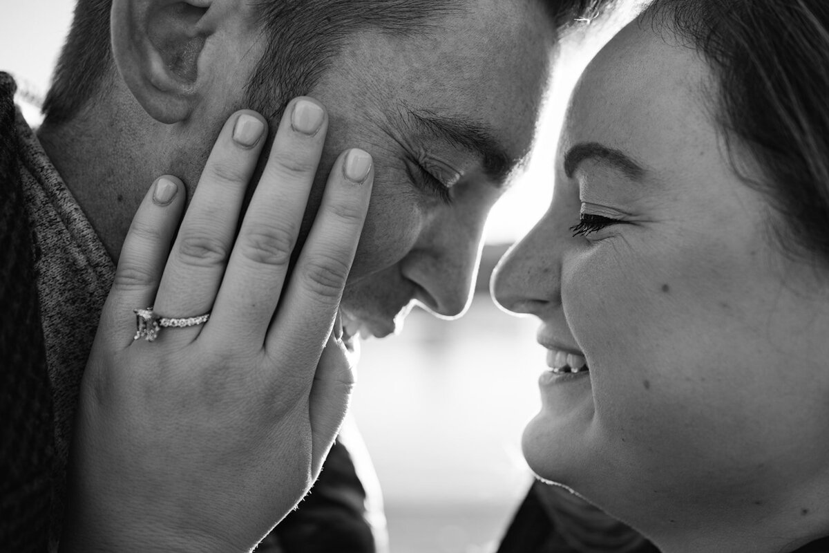 newly engaged couple embracing and smiling