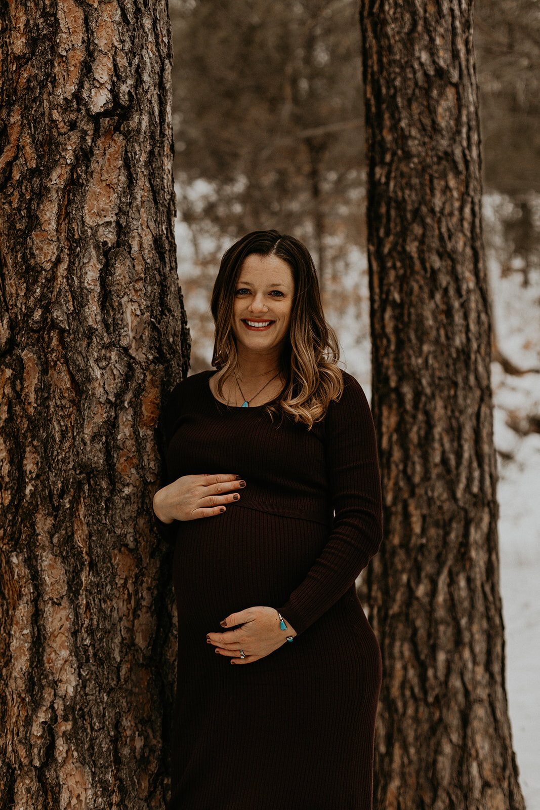 pregnant woman standing in the forest