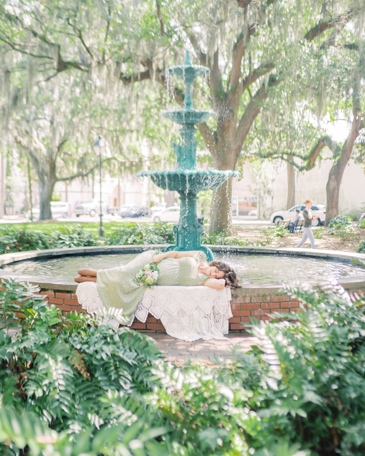 Portrait of pregnant mother larying near the fountain at Lafayette Square by Savannah FamilY Photographer Courtney Cronin