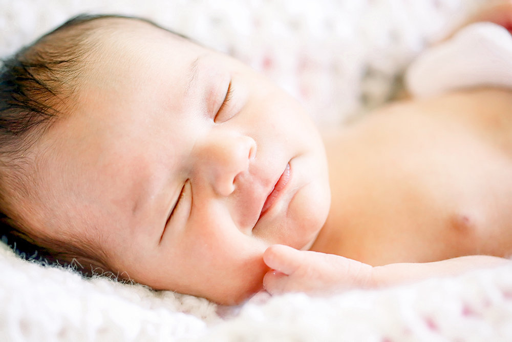 newborn smiling while sleeping