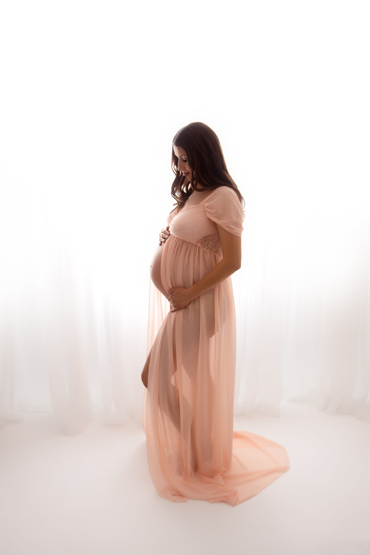 Pregnant mother in a peach dress