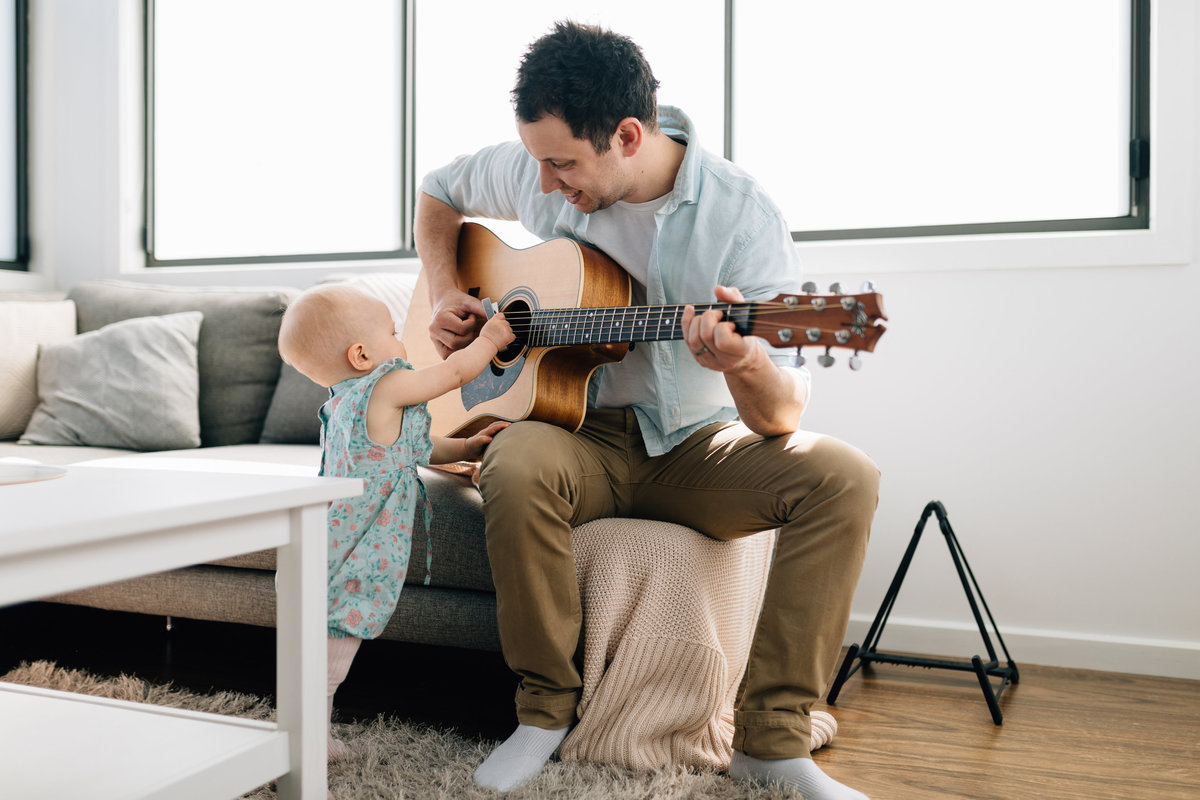 dad playing guitar to daughter lifestyle Melbourne family photography And So I Don’t Forget Photography