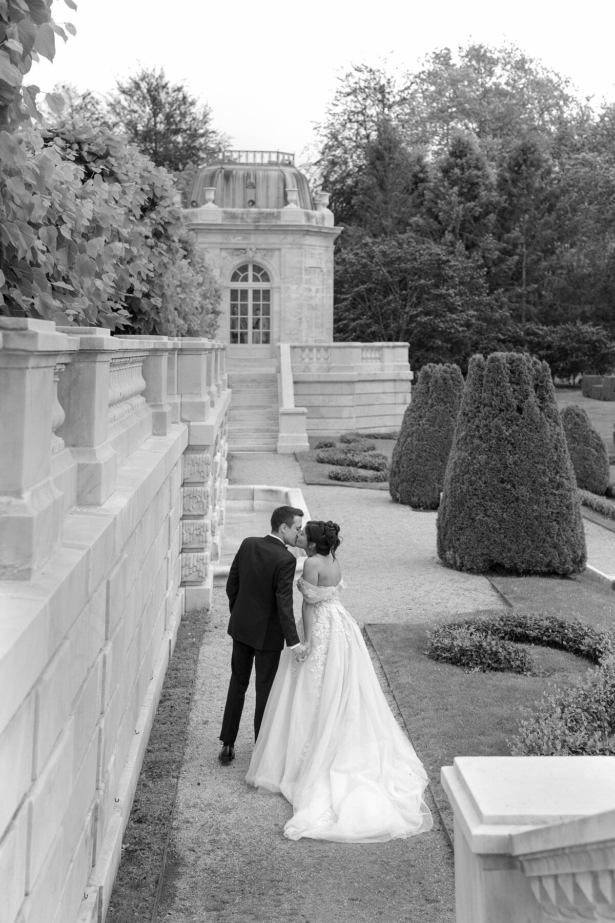 Bride and Groom kiss in the sunken garden at The Elms Mansion in Newport, Rhode Island.