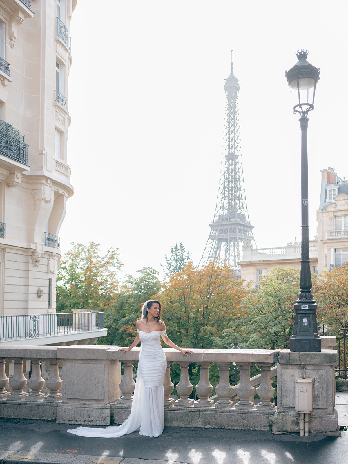 Bride posing in a street with the Eiffel Tower in background