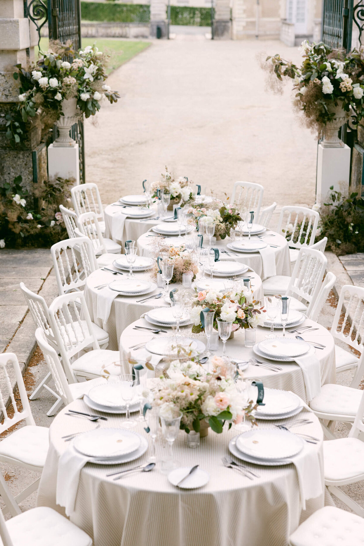 A wedding day photo of the dinner table on a bridge over the moat at Chateau de Jalesnes in France