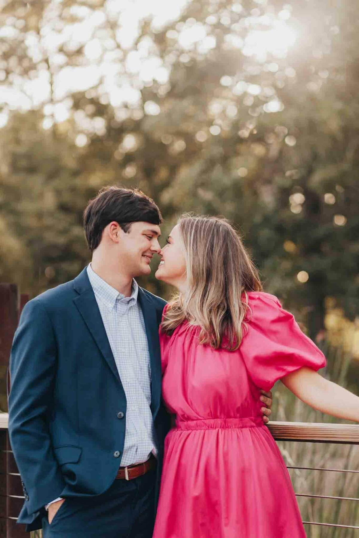 fiances snuggle each other closely at their engagement session in houston wtih ally's photography