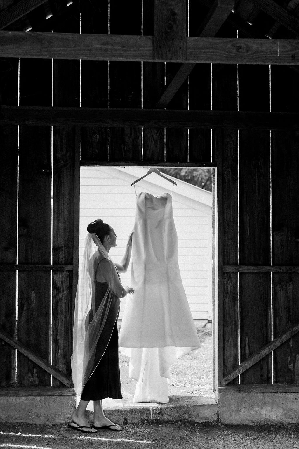 bride with dress hanging
