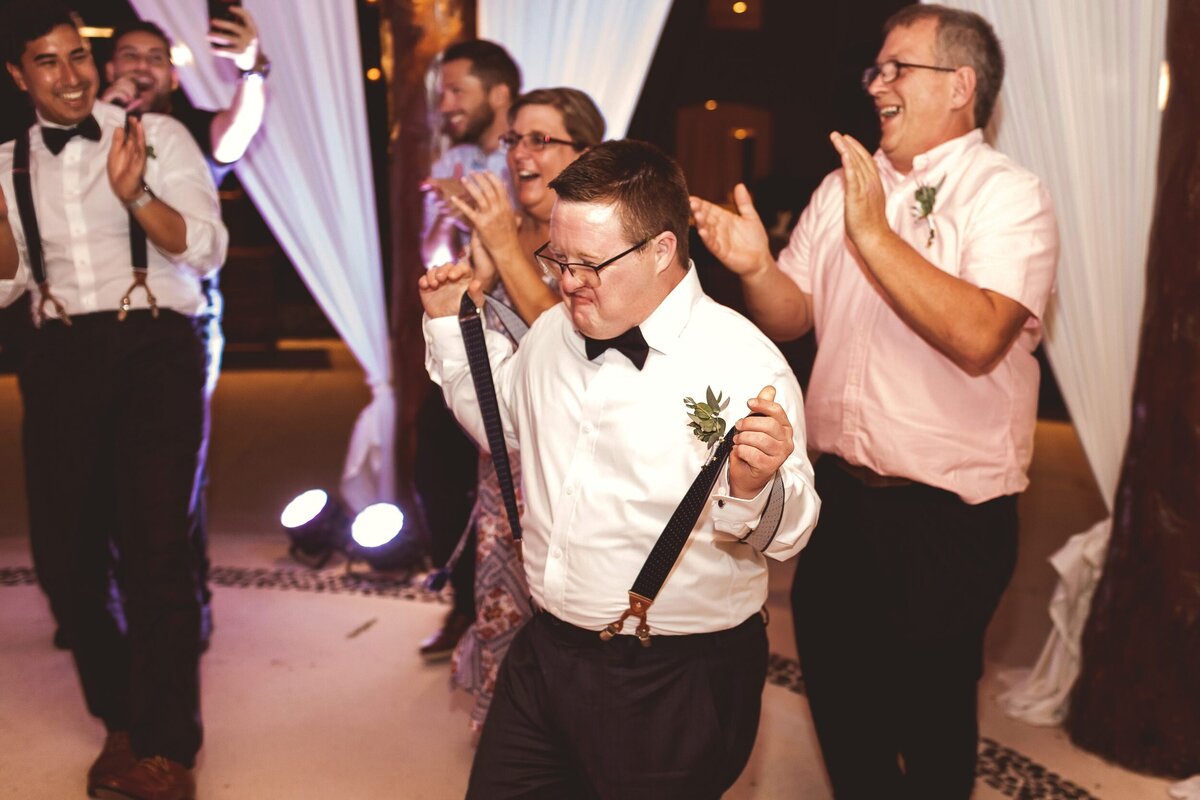 Groomsman dancing and having fun at wedding in Riviera Maya