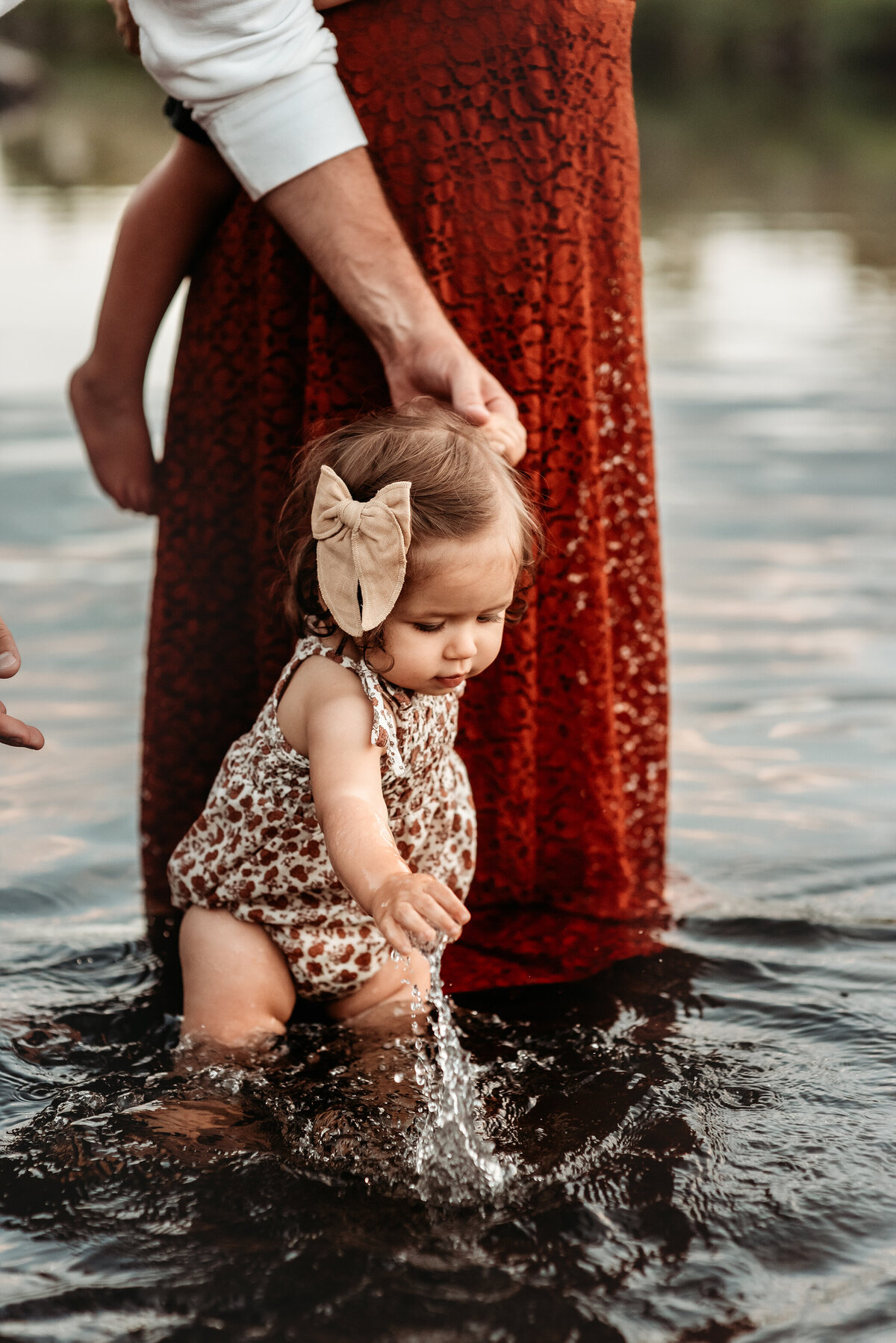denver family photography of baby girl splashing in the river