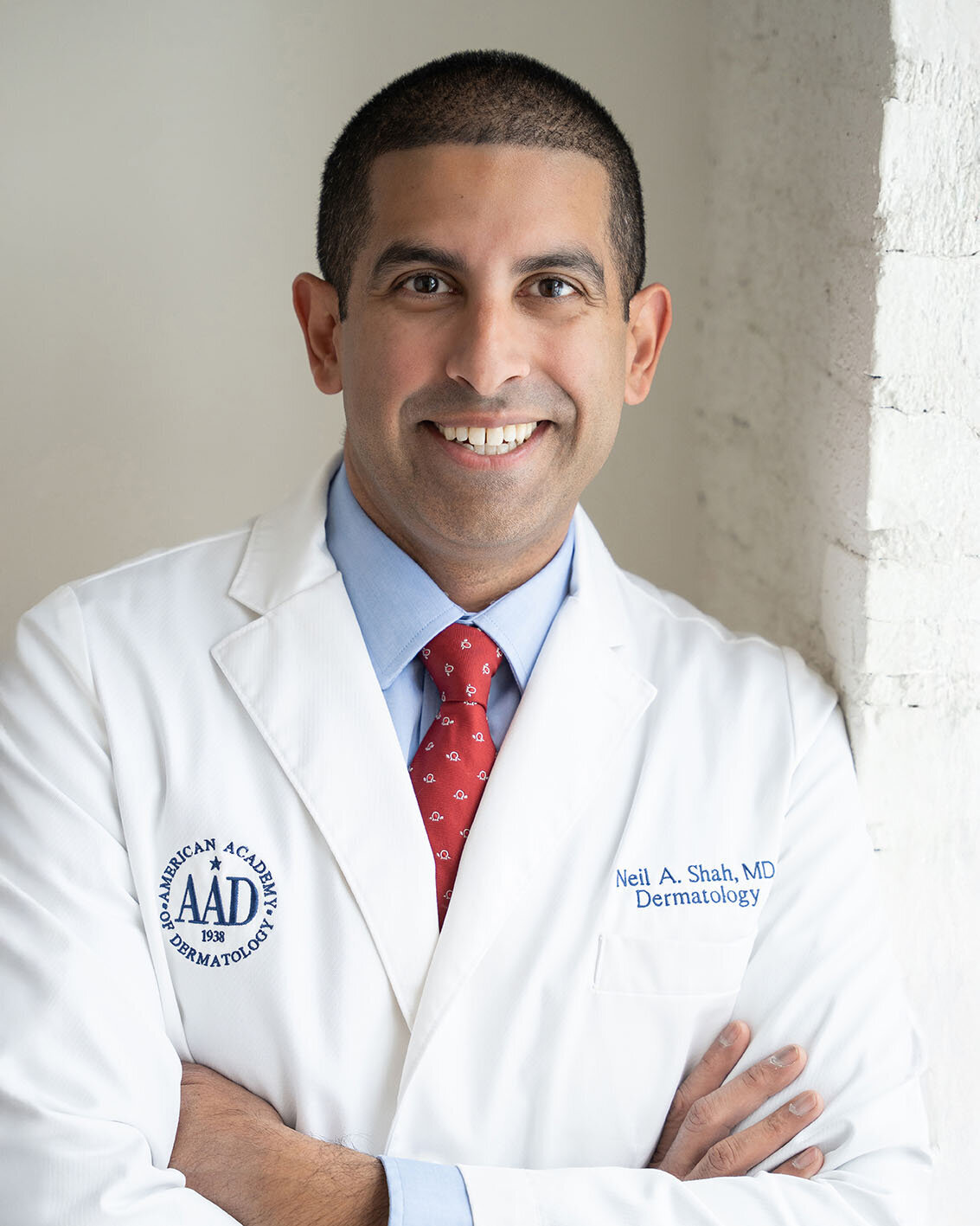 doctor-in-lab-coat-smiling-for-headshot