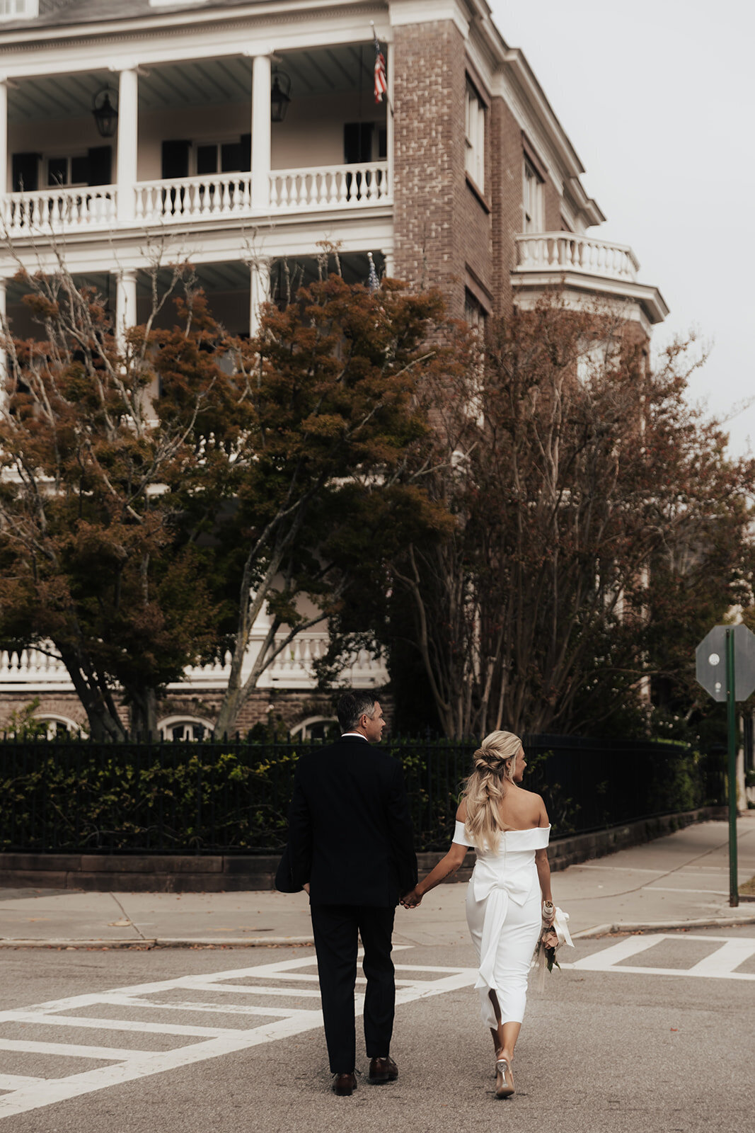 Couple crossing street in Charleston after eloping