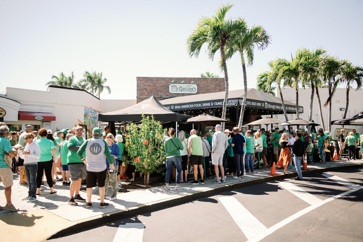 St. Patrick's Day celebration outside the front of McGregor's Public House. You can see a large crowd of happy people all dressed in green.