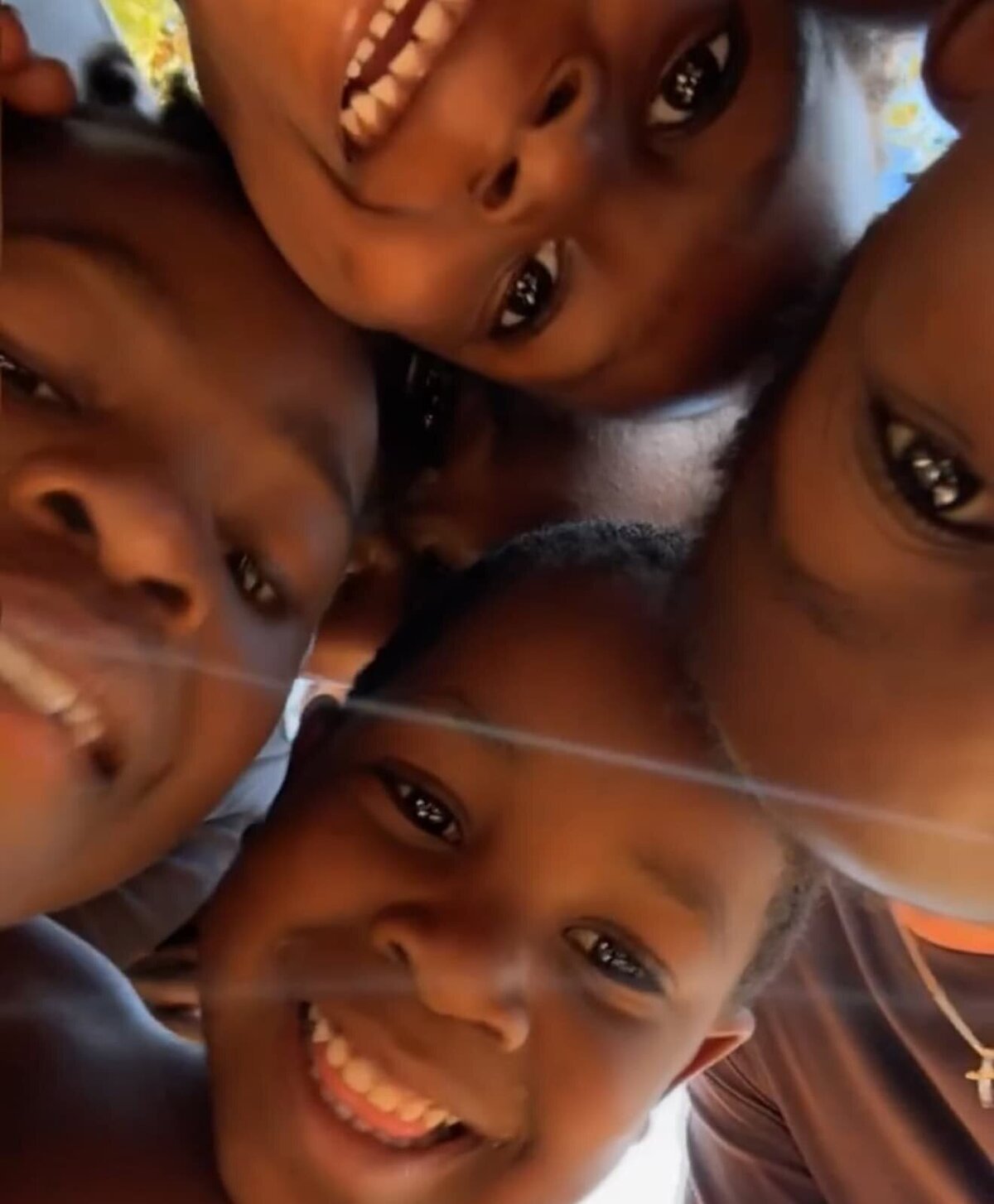 Four african children smiling down at the camera