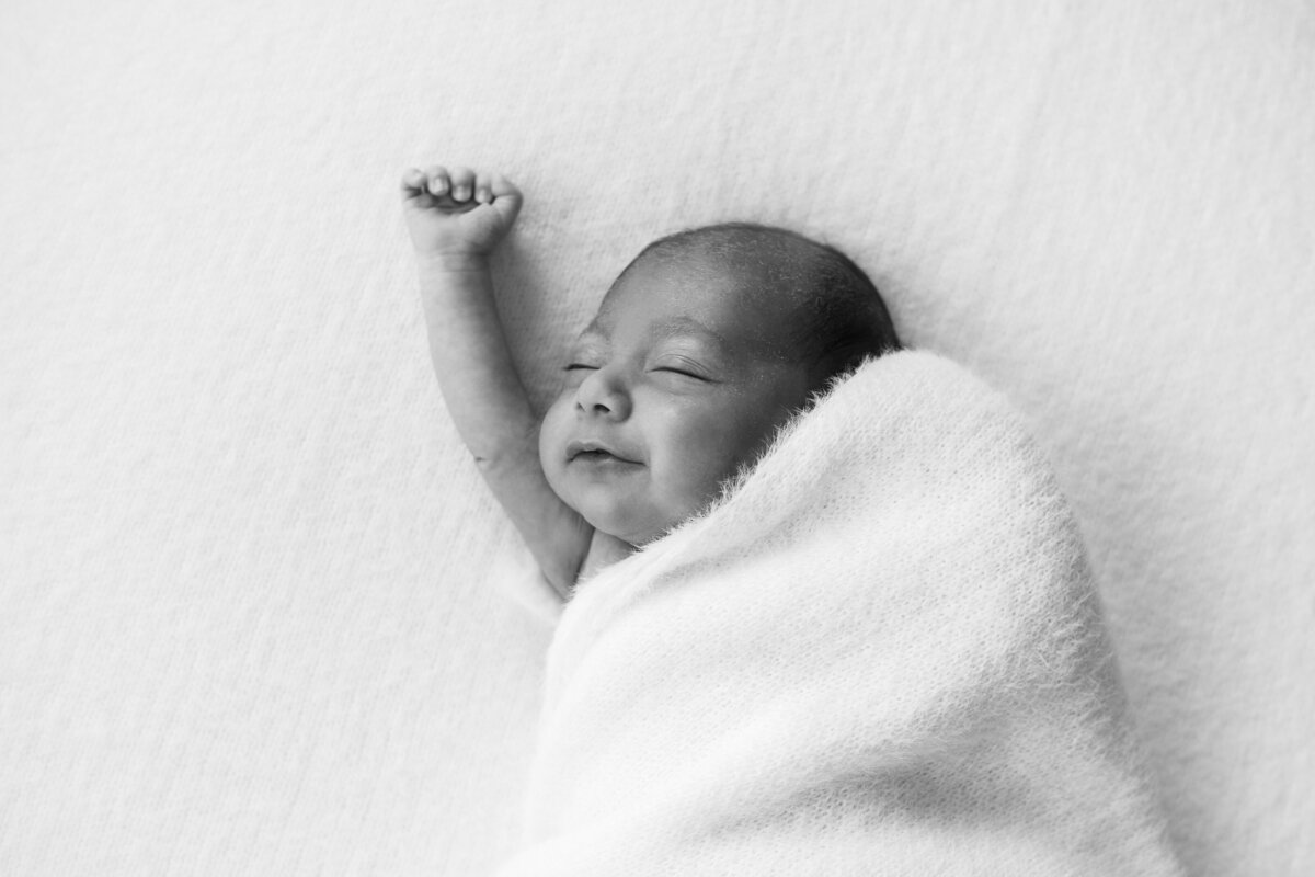 Stretching yawns of newborn in gerrards cross in home photoshoot