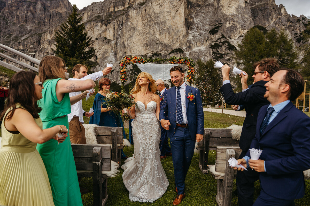 Bride and groom sharing laughter with family after Dolomites ceremony