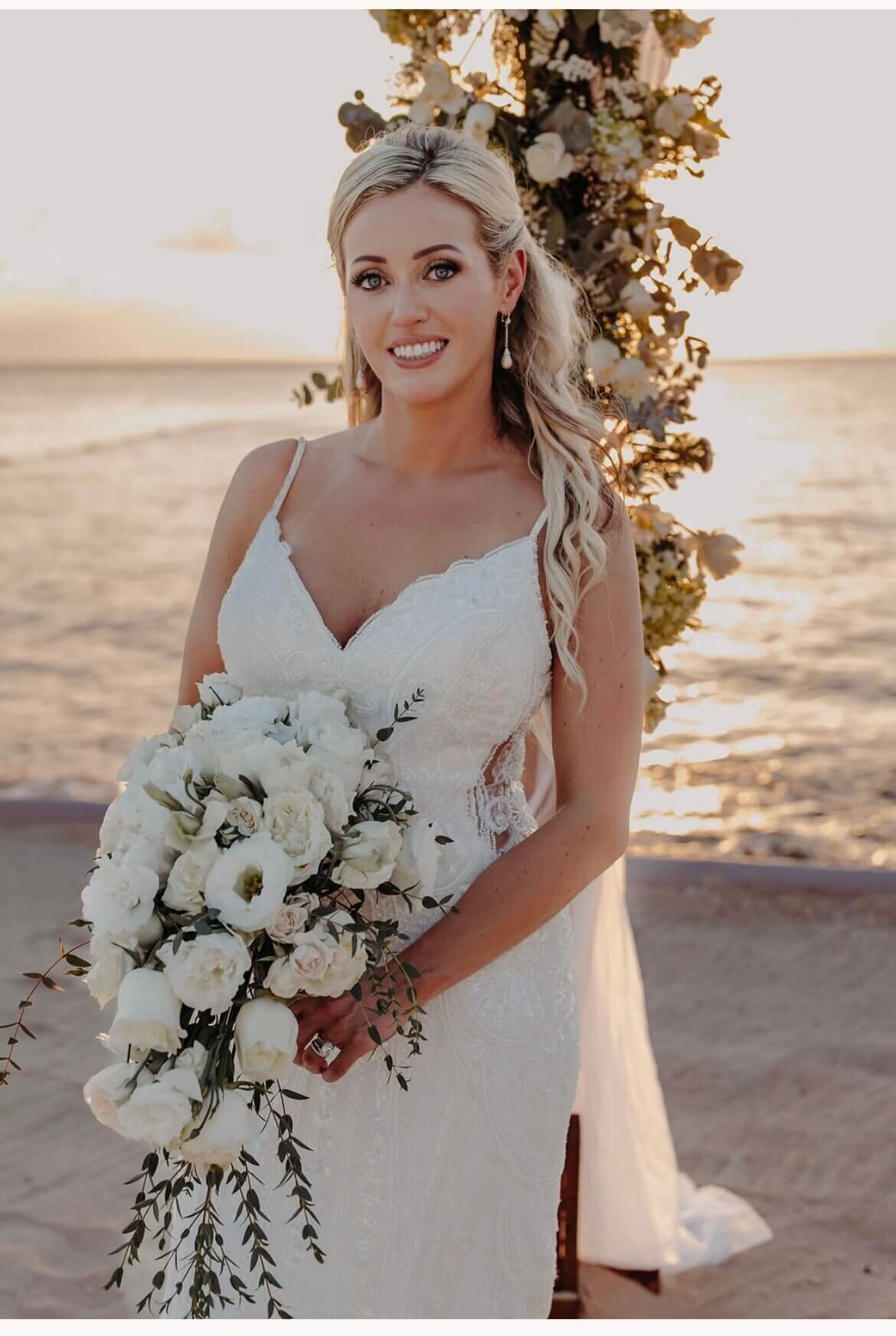 This radiant bride stuns at her destination wedding with soft glam waves and flawless natural makeup. Mistique Makeup’s wedding mobile hair and makeup team travels to your venue, offering personalized beauty services for your big day. Book a Mobile Makeup Artist near you for bridal elegance on location.
