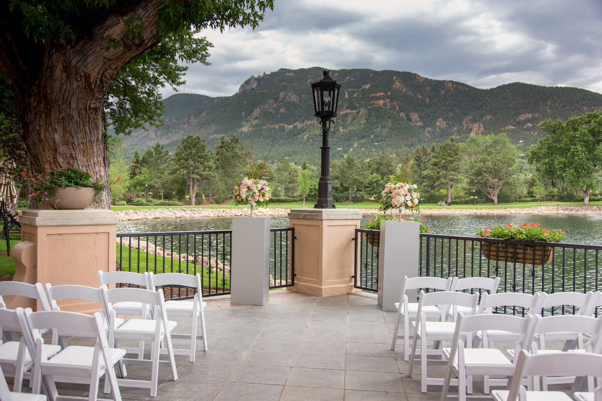 Broadmoor's South Terrace is set up with White Chairs for a wedding ceremony