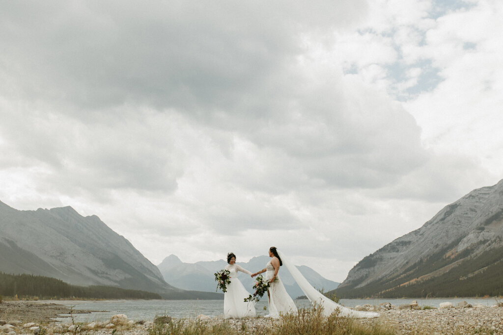 Same sex brides in the mountains captured by Court Amber Photography, joyful and adventurous wedding photographer in Calgary, Alberta. Featured on the Bronte Bride Vendor Guide.