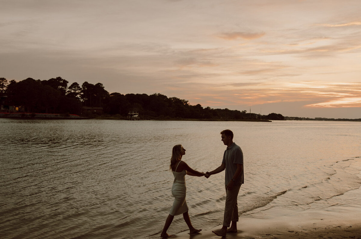 Couple roaming virginia beach during sunset