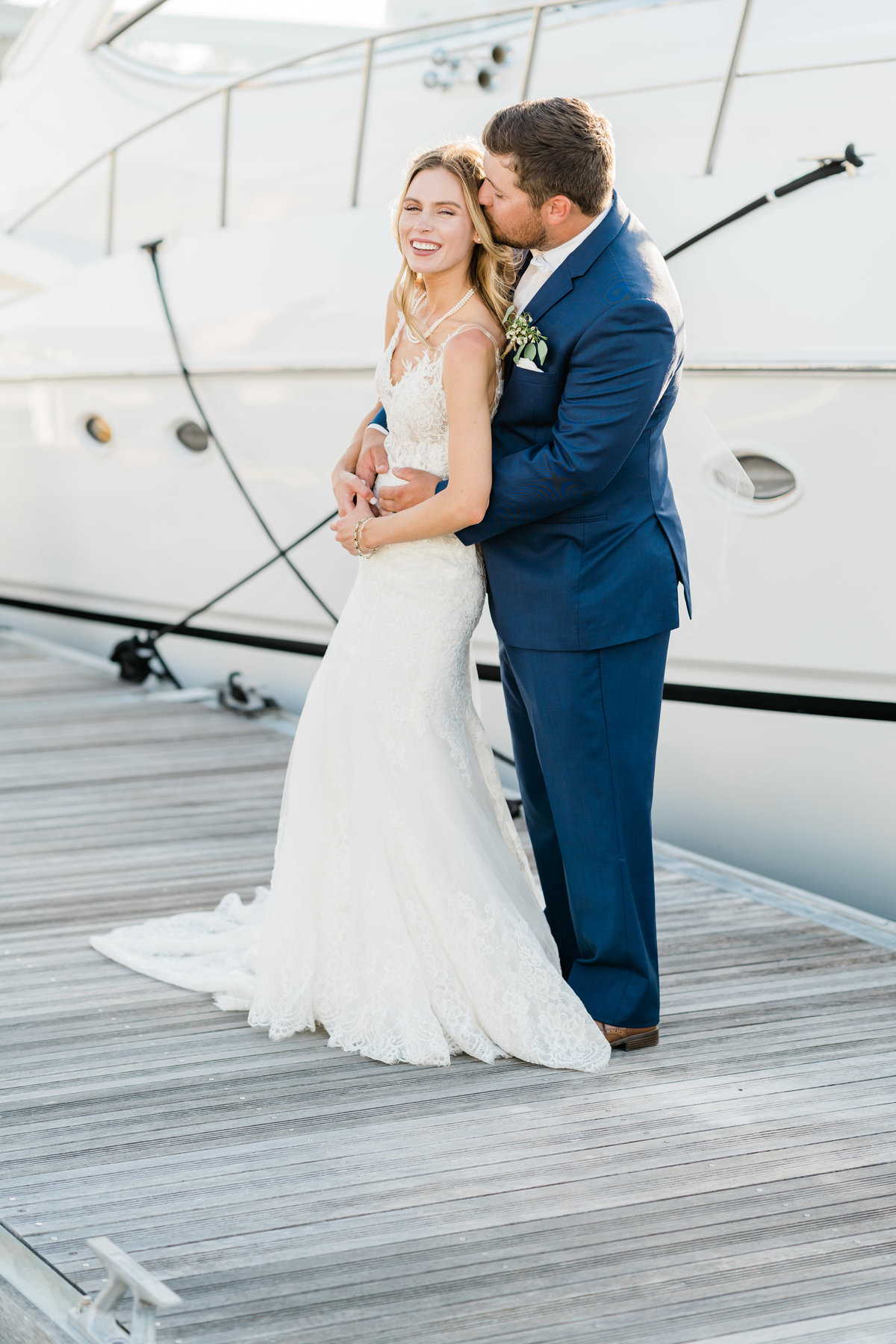 Bride and groom standing on dock in Alabama