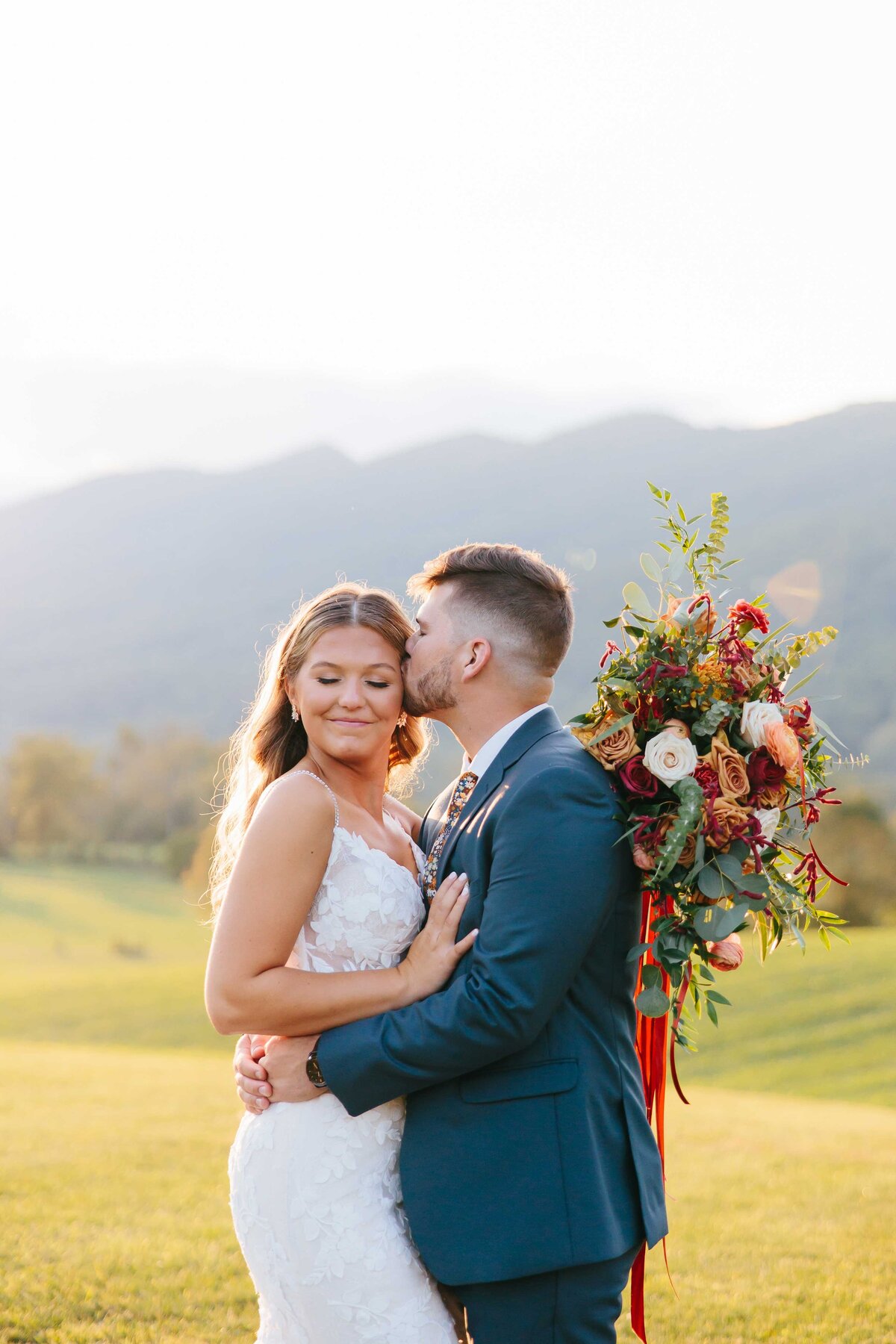 bride and groom temple kiss crooked river wedding