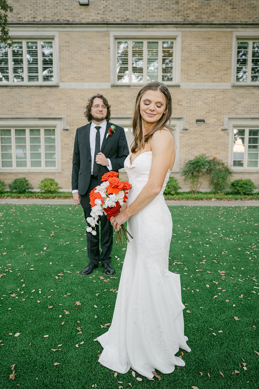 Groom looks at Bride during her bridal portraits at their luxury wedding estate wedding in the gardens of San Antonio Texas.