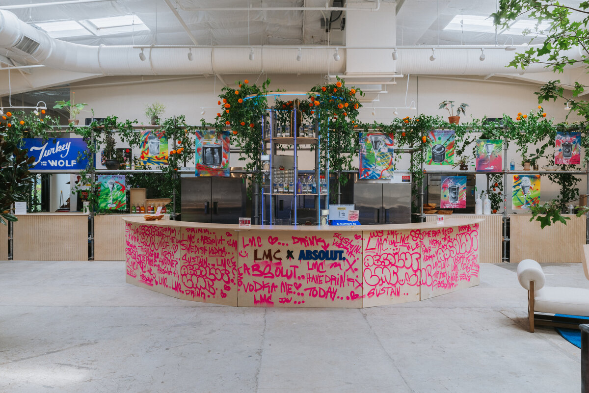 Absolut Vodka × Like Minded Creatures graffiti-wrapped bar installation with greenery and artwork