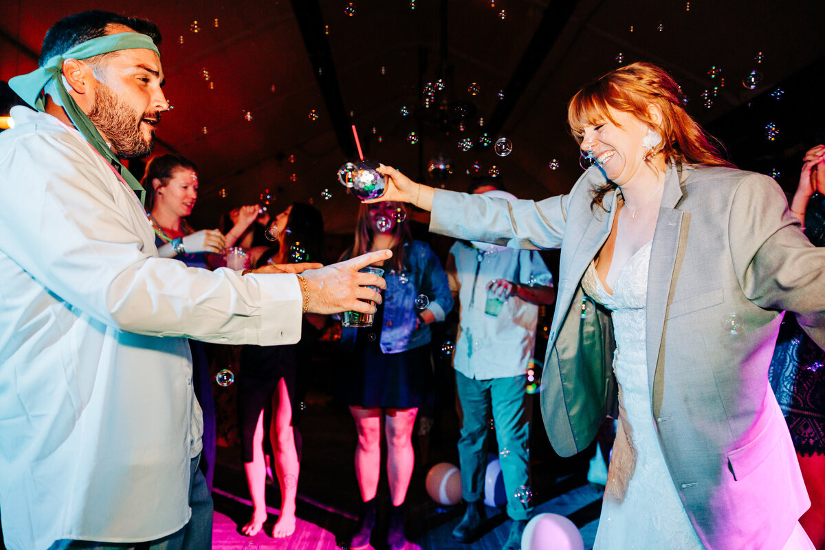 Bride dancing with guest during wedding reception at Headwaters Grille in Big Sky, MT
