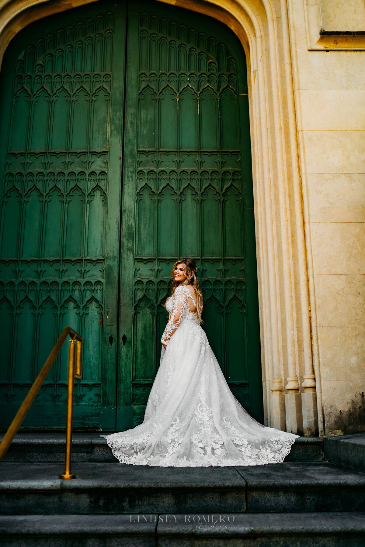 bride poses in front of large antique door at old state capital in baton rouge, la