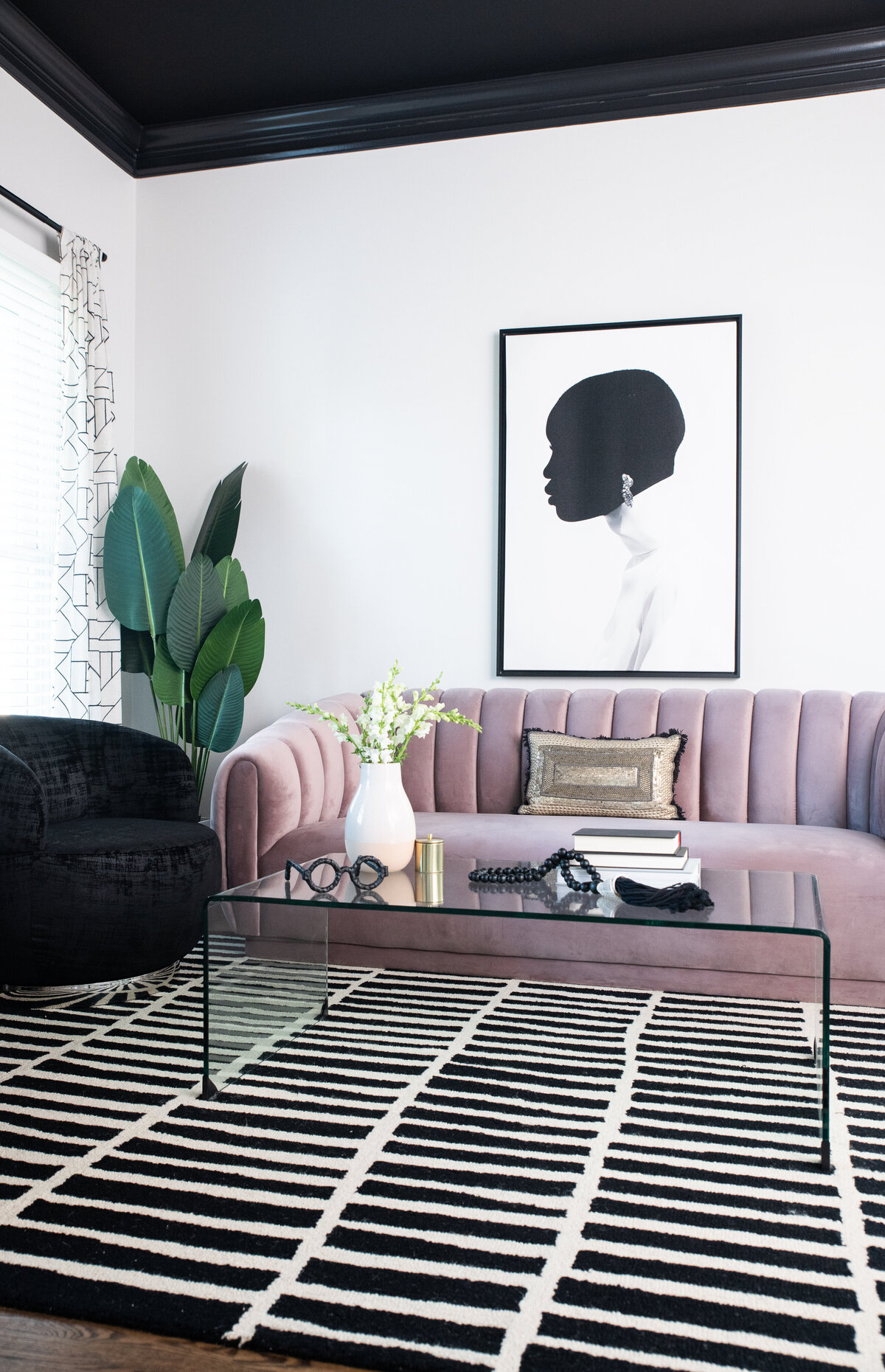 a lavender couch providing a pop of color in a black and white living room