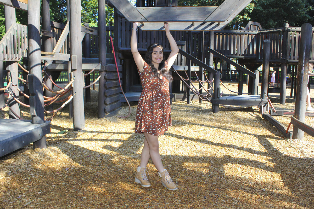 Young lady posing with park playground structure