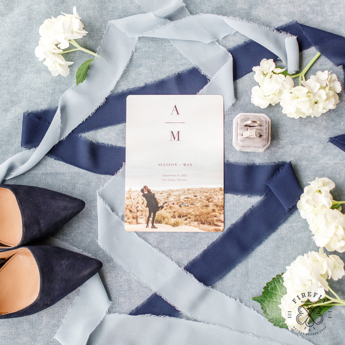 wedding invitation rings and navy blue shoes with white hydrangeas by Firefly Photography