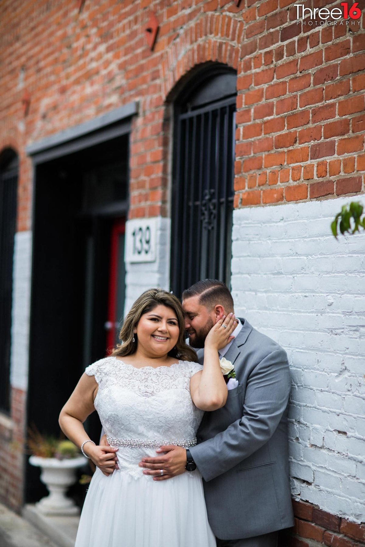 Groom embraces his Bride in photo session in Downtown Orange