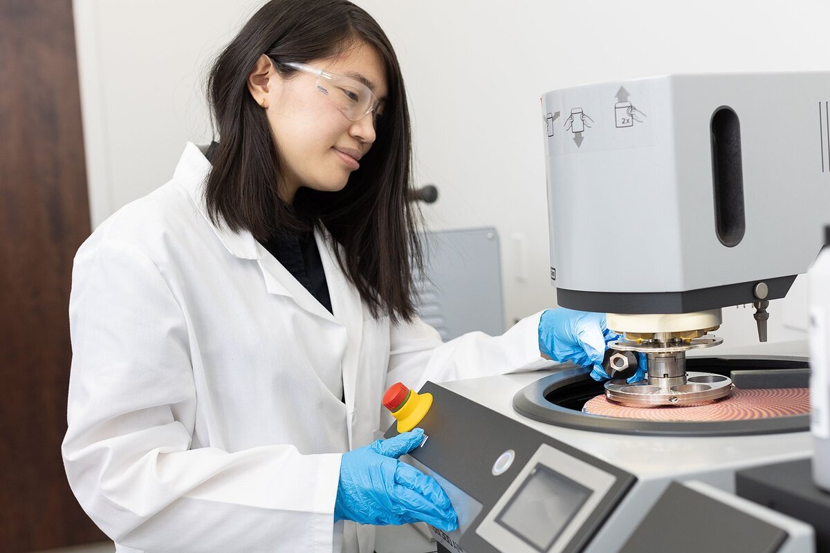 Female scientist working on a machine