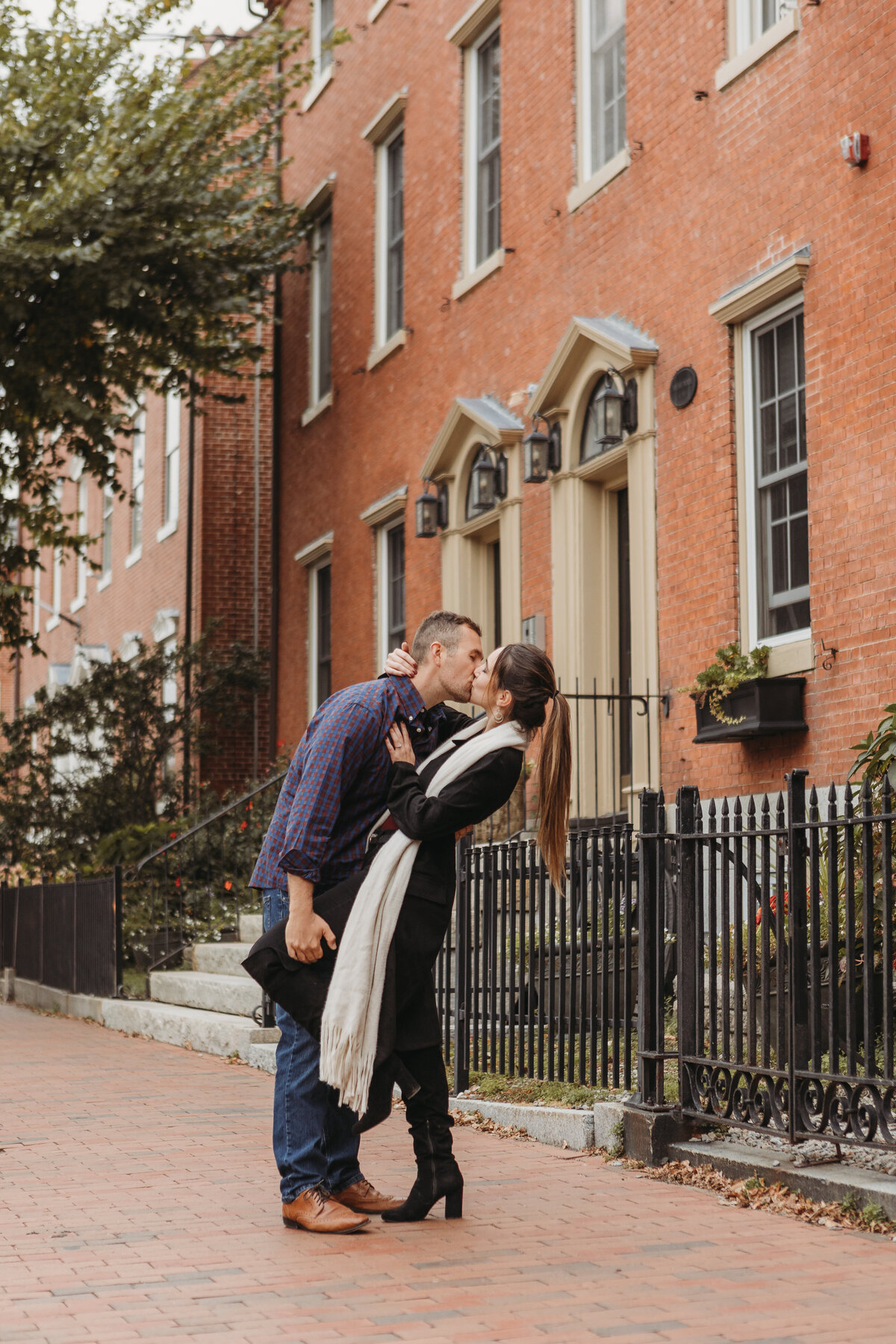 couple kissing on sidewalk