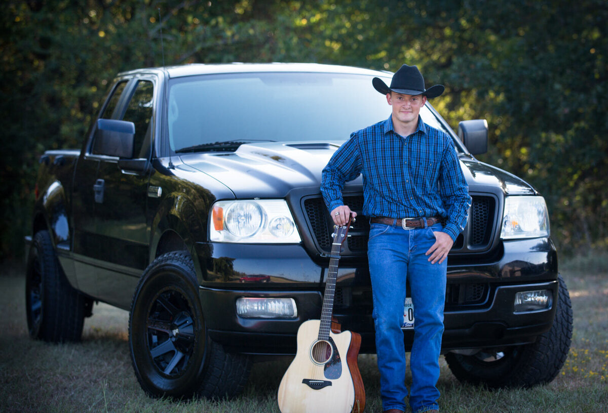 senior-boy-standing-by-truck-with-guitar