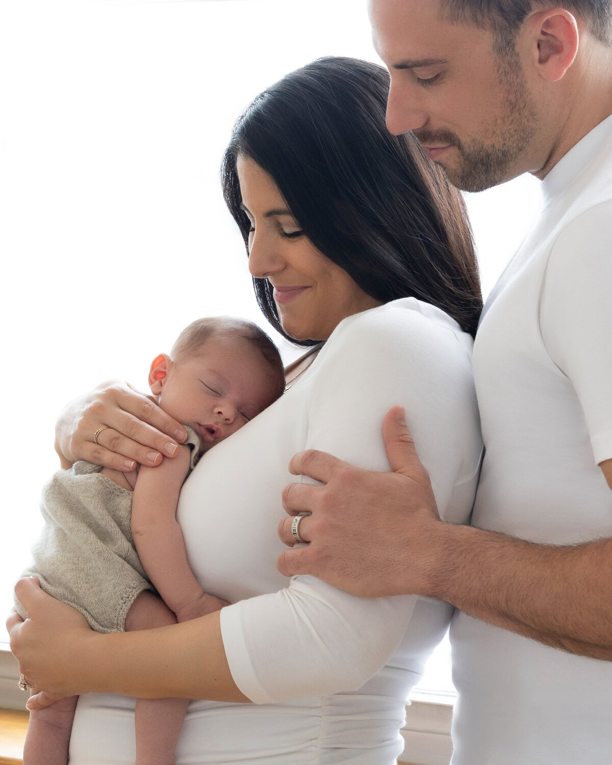 Beautiful portrait of parents and their newborn baby by Daisy Rey Photography