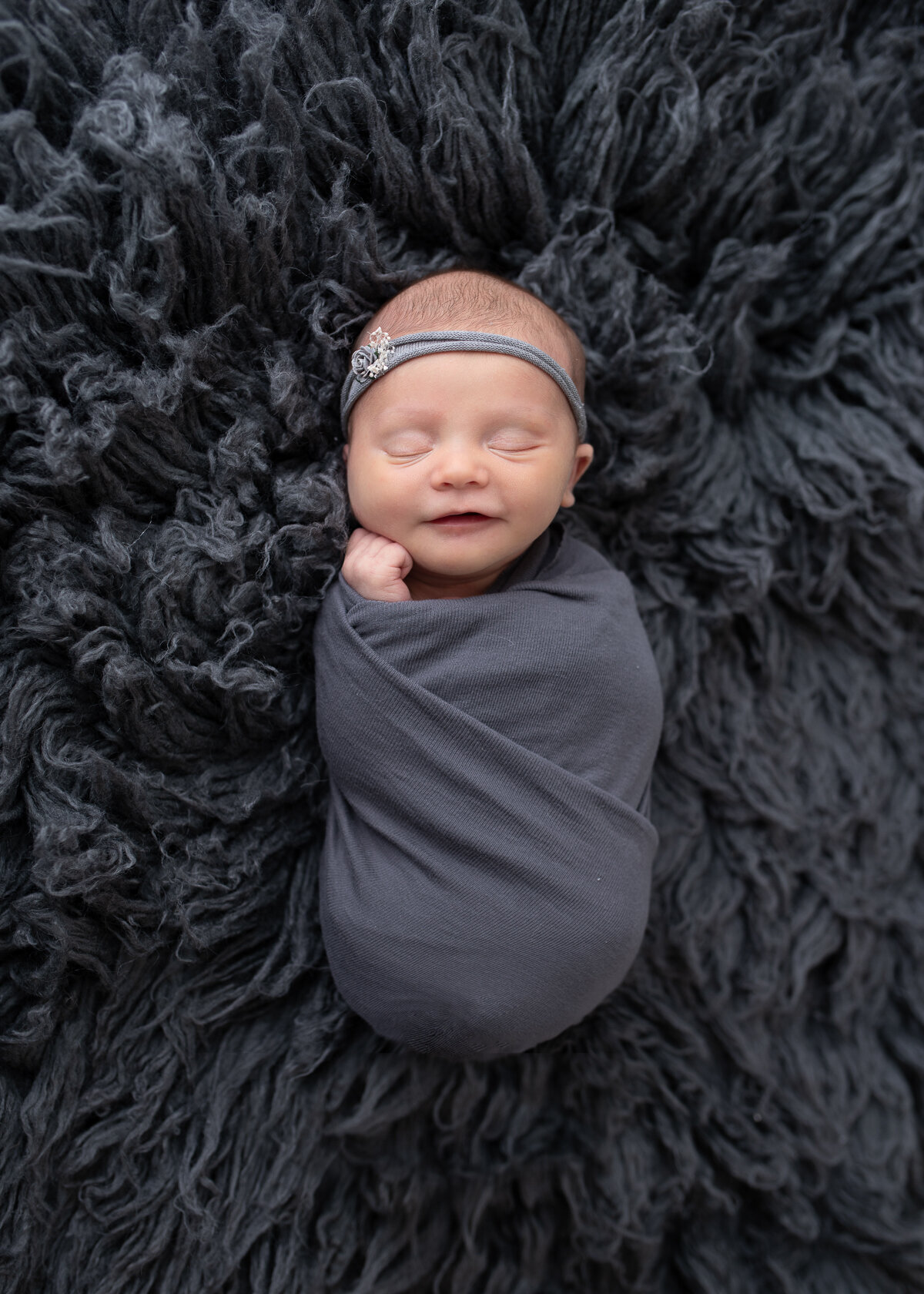 Wrapped newborn in Grey Furry Background