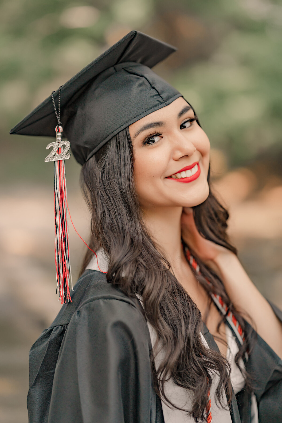 Close-up senior portrait of a San Antonio graduate in her cap and gown.